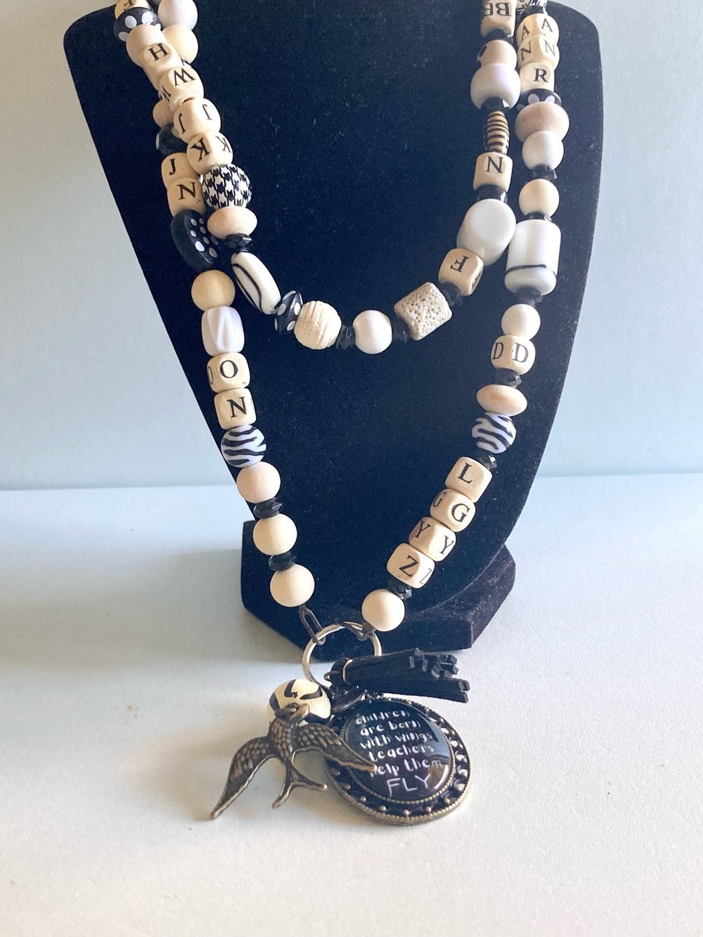 NWOT Plunder Black and Cream Beaded Pendant lanyard with Inspirational Charm
